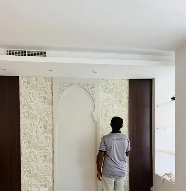 Silver Walls installer fitting a mural